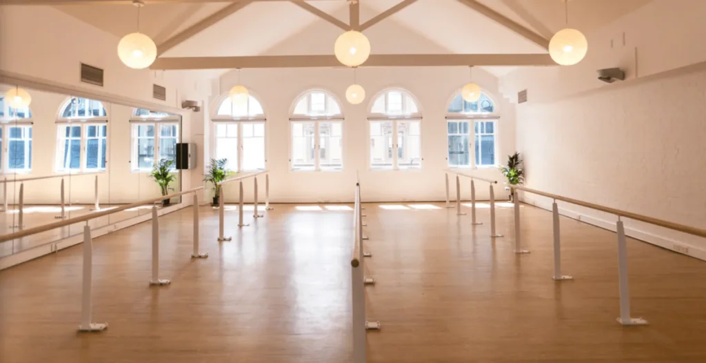 Floor-fixed Pilates stanchions in a heritage hall at Barre Body Brisbane