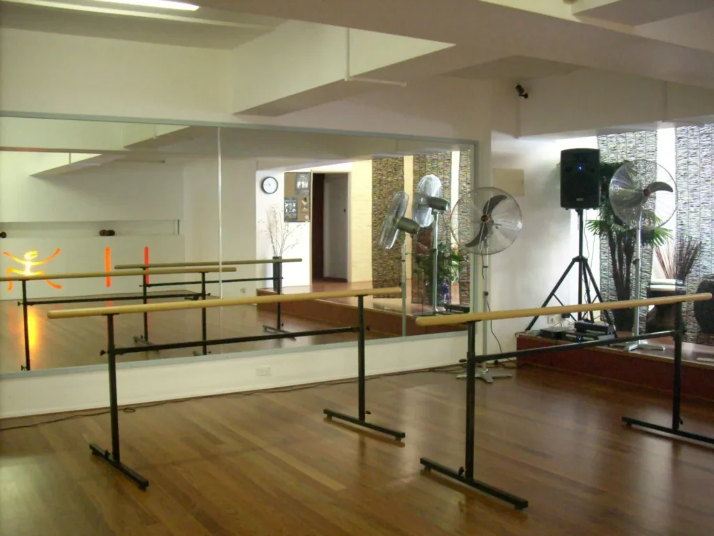 Portable STM ballet barre in front of a mirror wall on a timber floor