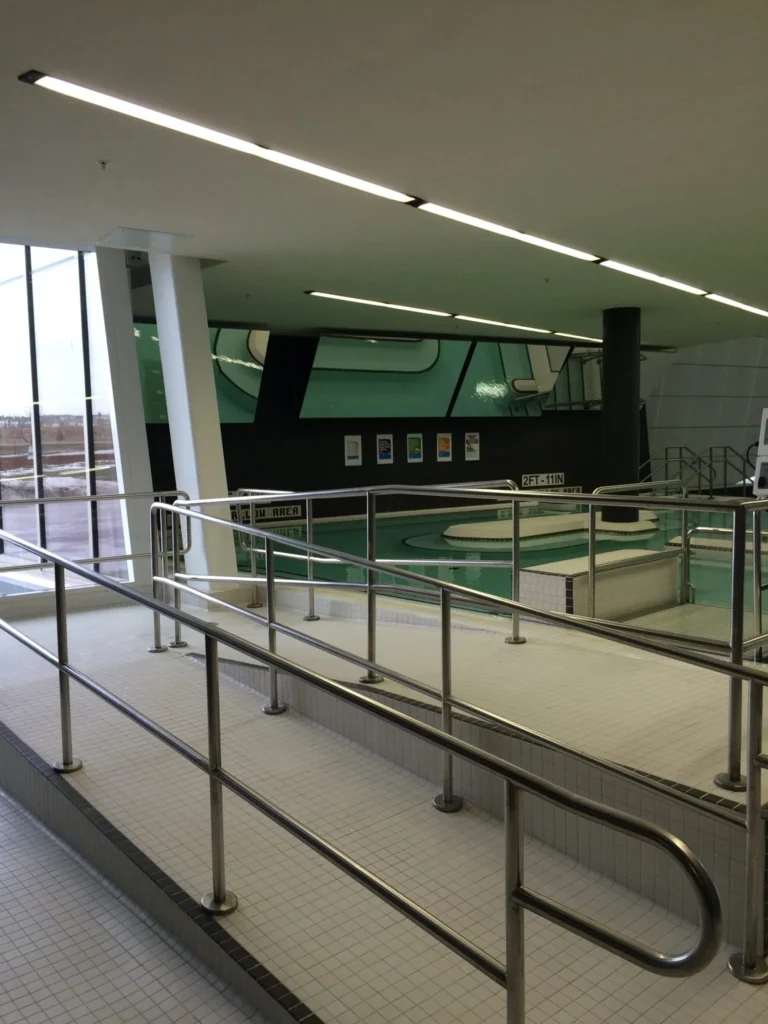 Mirrorlite Mylar mirror panel installed beside an indoor pool