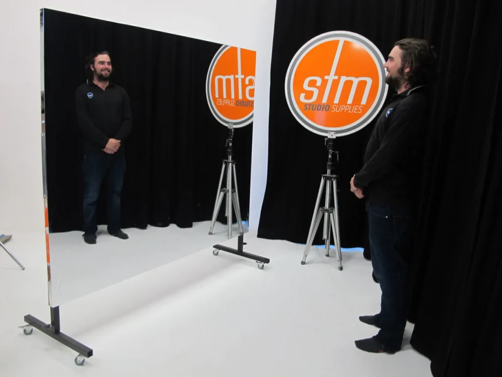 Two STM staff reflected in a large rollaway Mylar glassless mirror in a studio