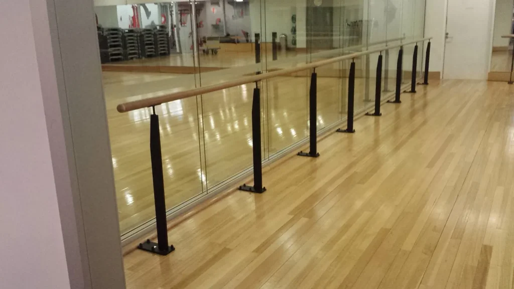 Floor-fixed Pilates barre stanchions in a Virgin Active club