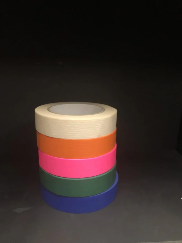 Rolls of white, orange, pink and green washi paper spike tape