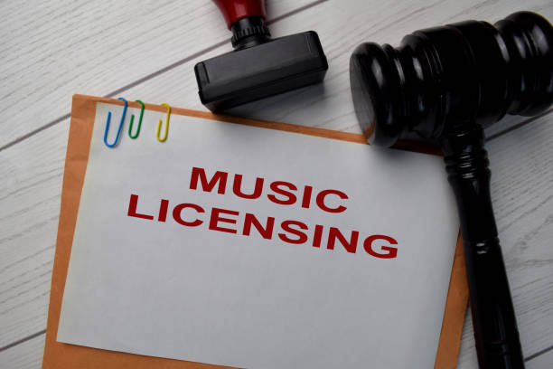 Music Licensing text with document brown envelope and stethoscope isolated on office desk.